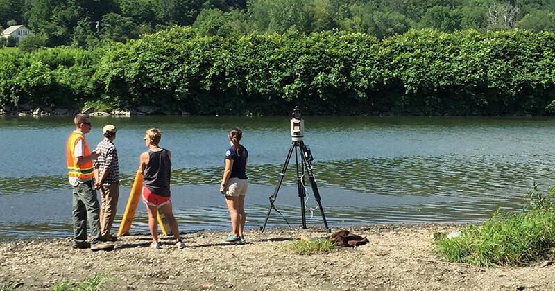 student researchers conducting field work along a river
