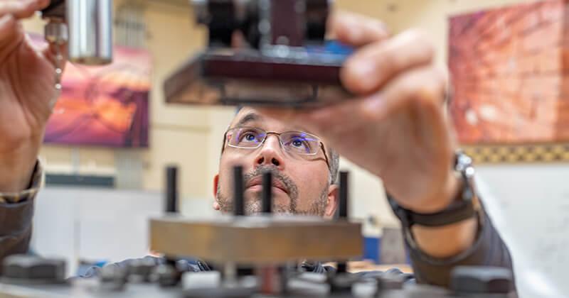 Civil Engineering professor Eric Hernandez adjusts equipment in his lab