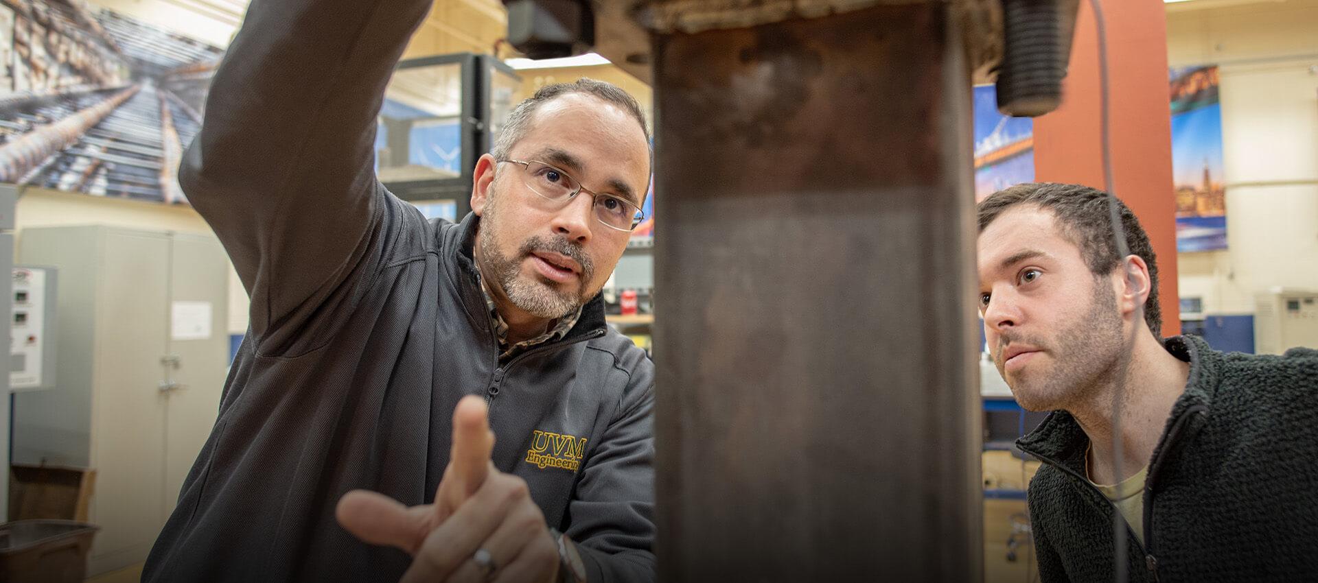 Civil Engineering professor Eric Hernandez shares equipment in the materials lab with a student