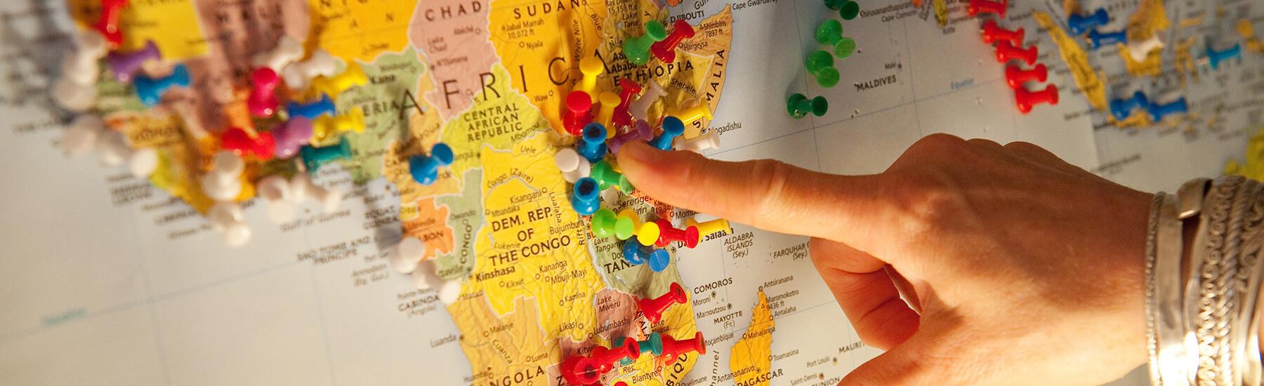 A hand pointing at a map