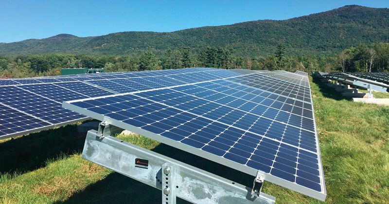 An array of solar panels in Vermont countryside
