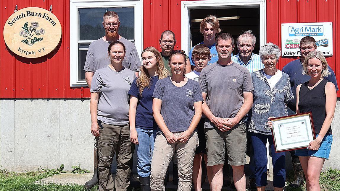 12 people standing outside a barn at Scotch Burn Farm