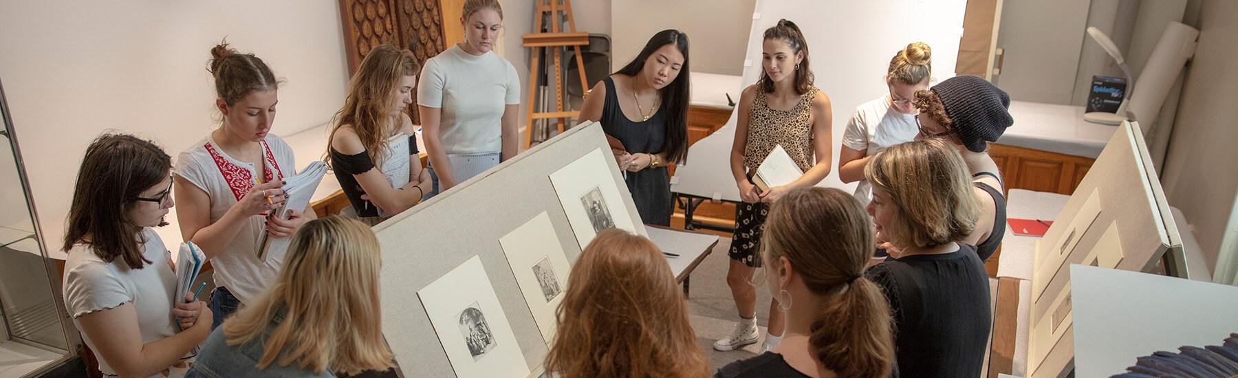 Group of student examining and studying old art