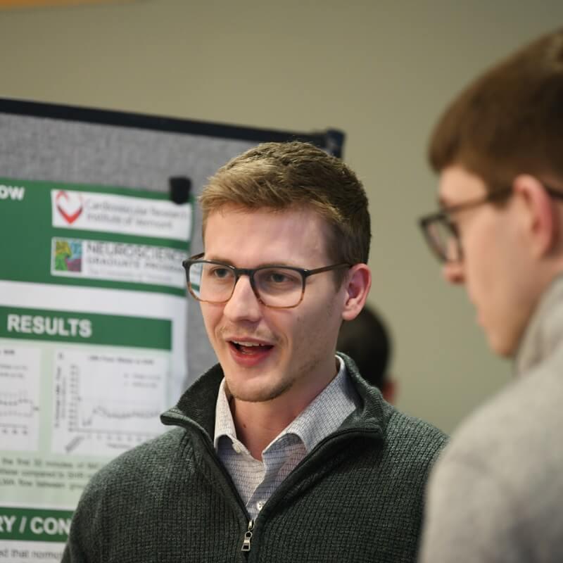 students discuss research