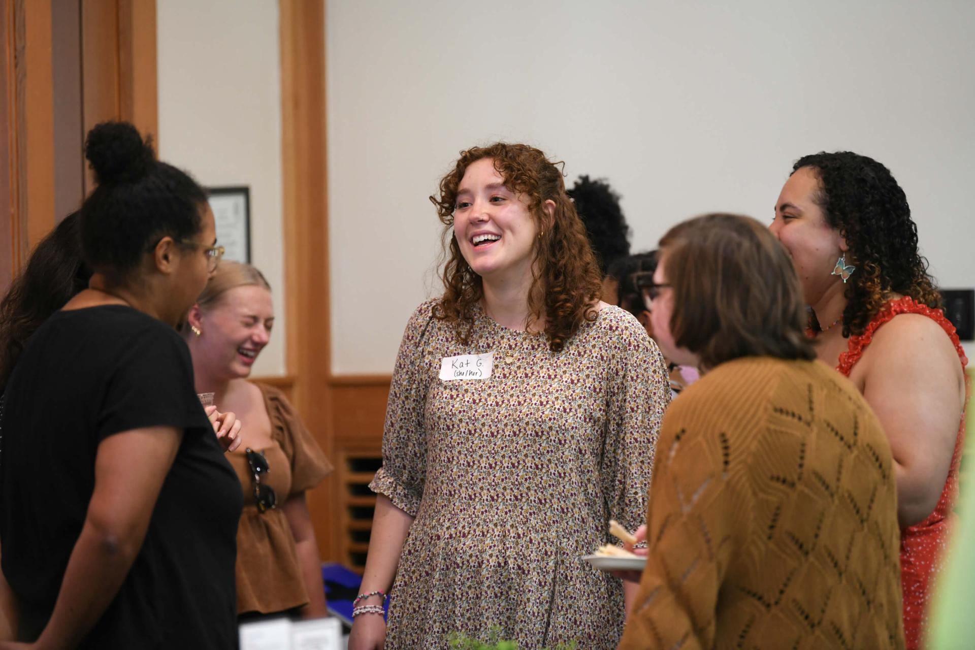 HESA students, faculty and staff mingle at an event.