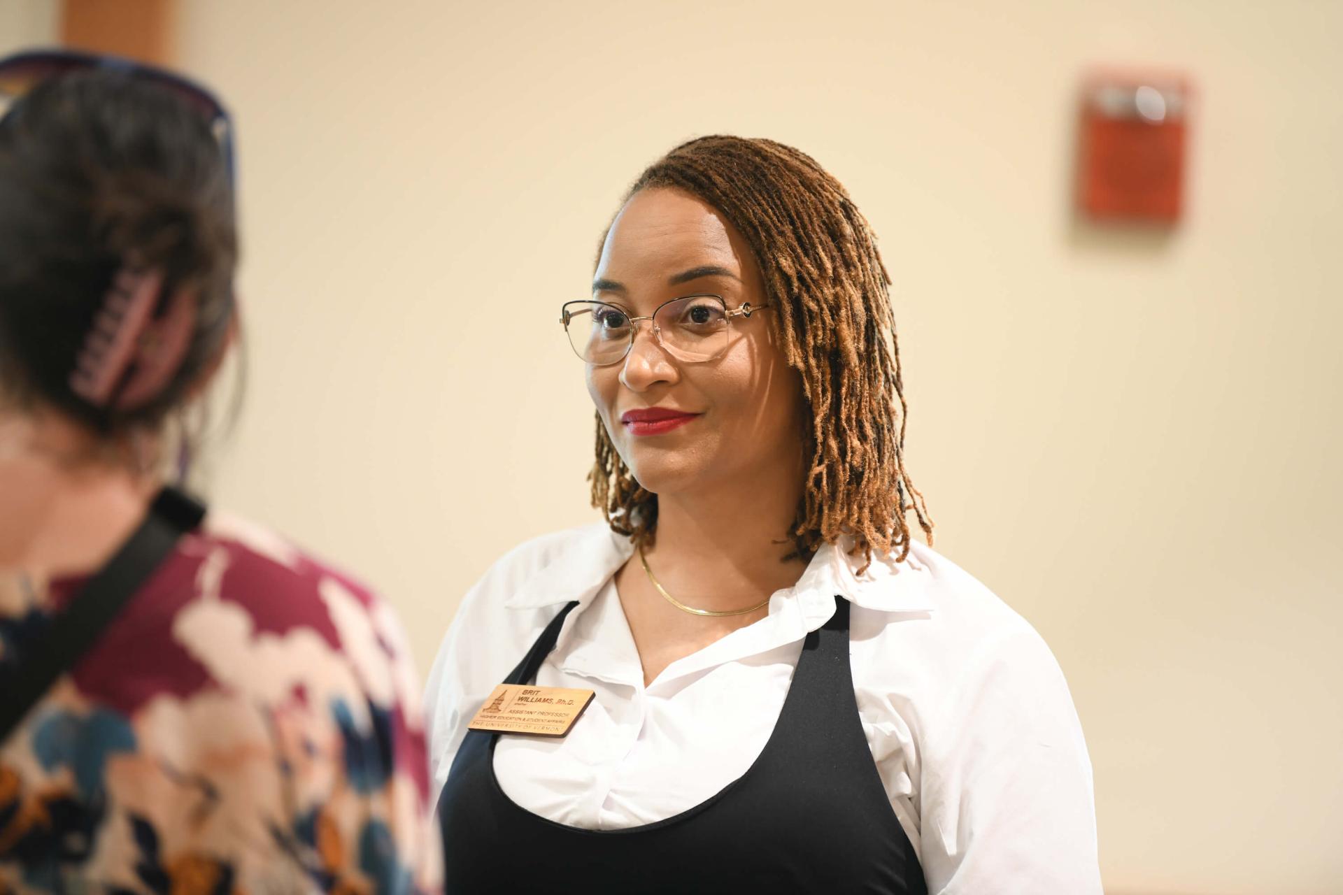 HESA faculty member Brit Williams listens to a student during their conversation.