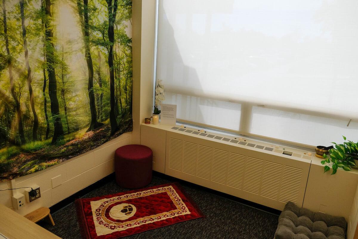 Photo of room with prayer rug on floor