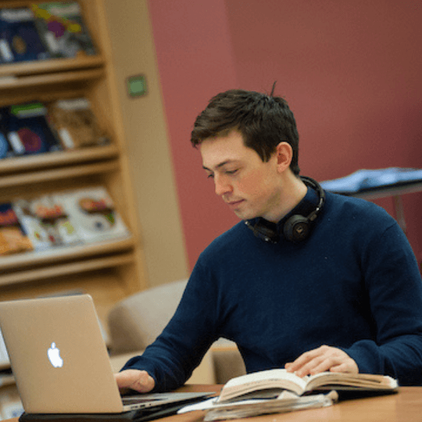 Male student studying with a laptop