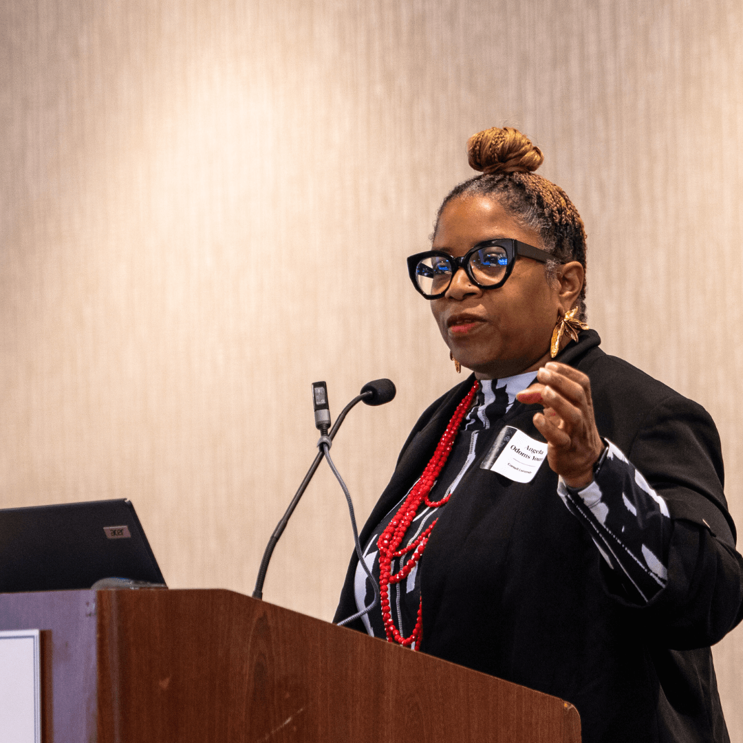 Angela Odoms Young speaking at podium