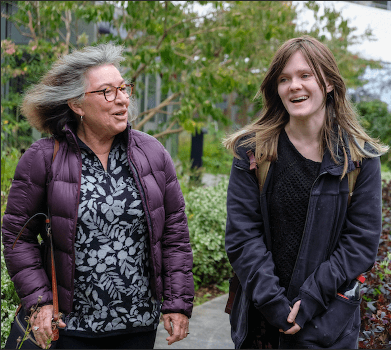 Older person and student walking 