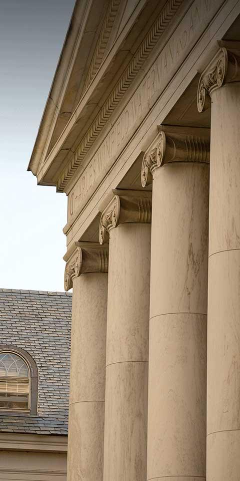 Large stone pillars in a Greek architectural style.