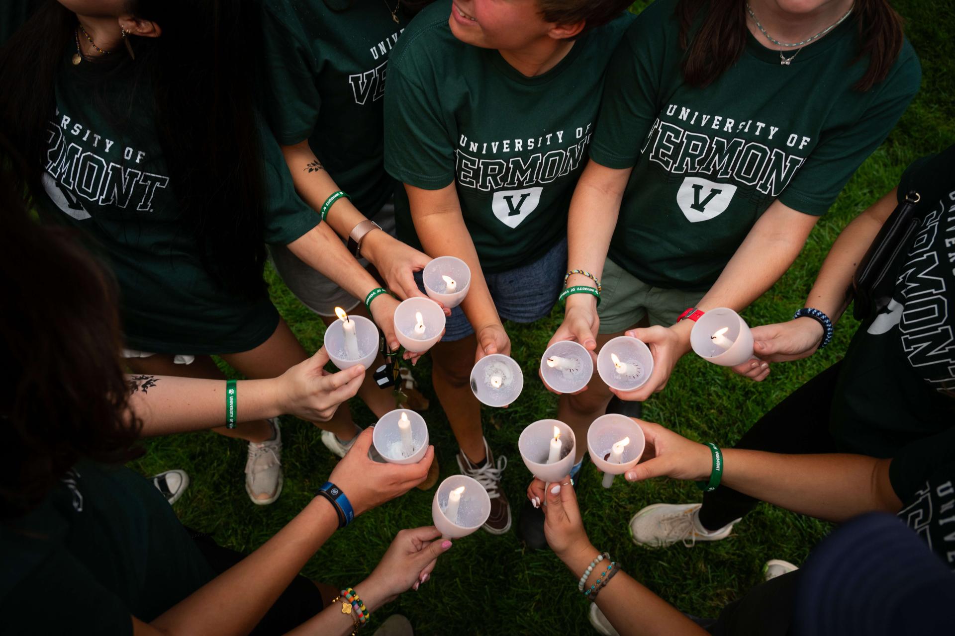 students holding candles
