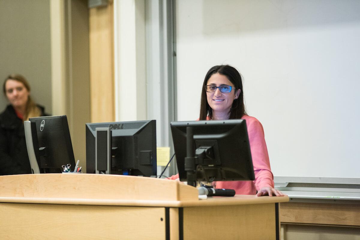 Woman standing in front of group speaking