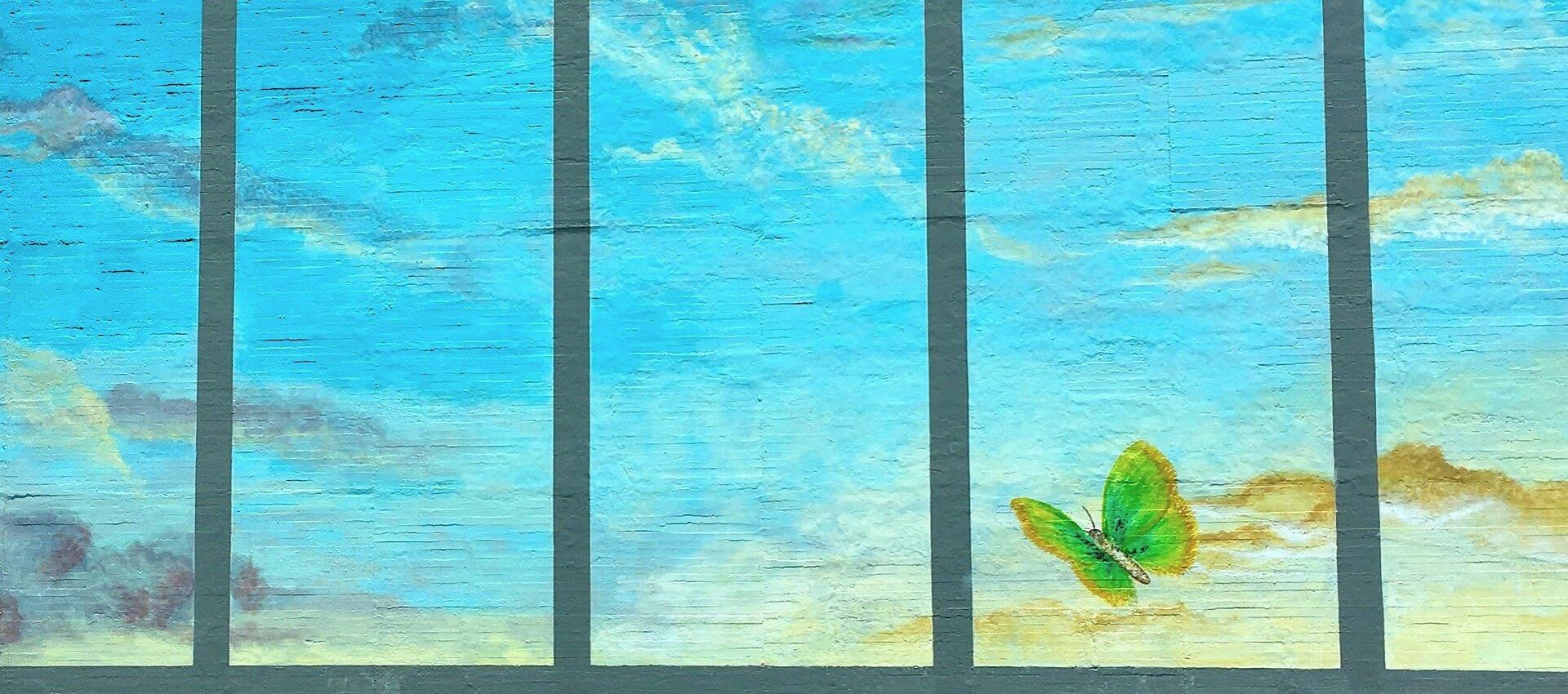 A mural of a butterfly among blue sky and clouds