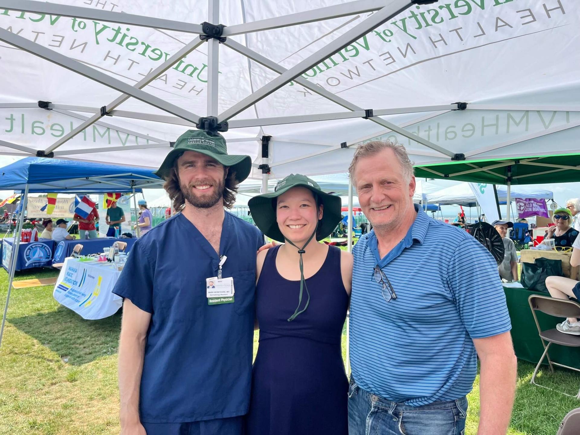 Dermatology residents Mark Derbyshire, M.D.,  and Sabrina Bennet, M.D. smile for a photo with Division director Joseph Pierson, M.D., professor of medicine.