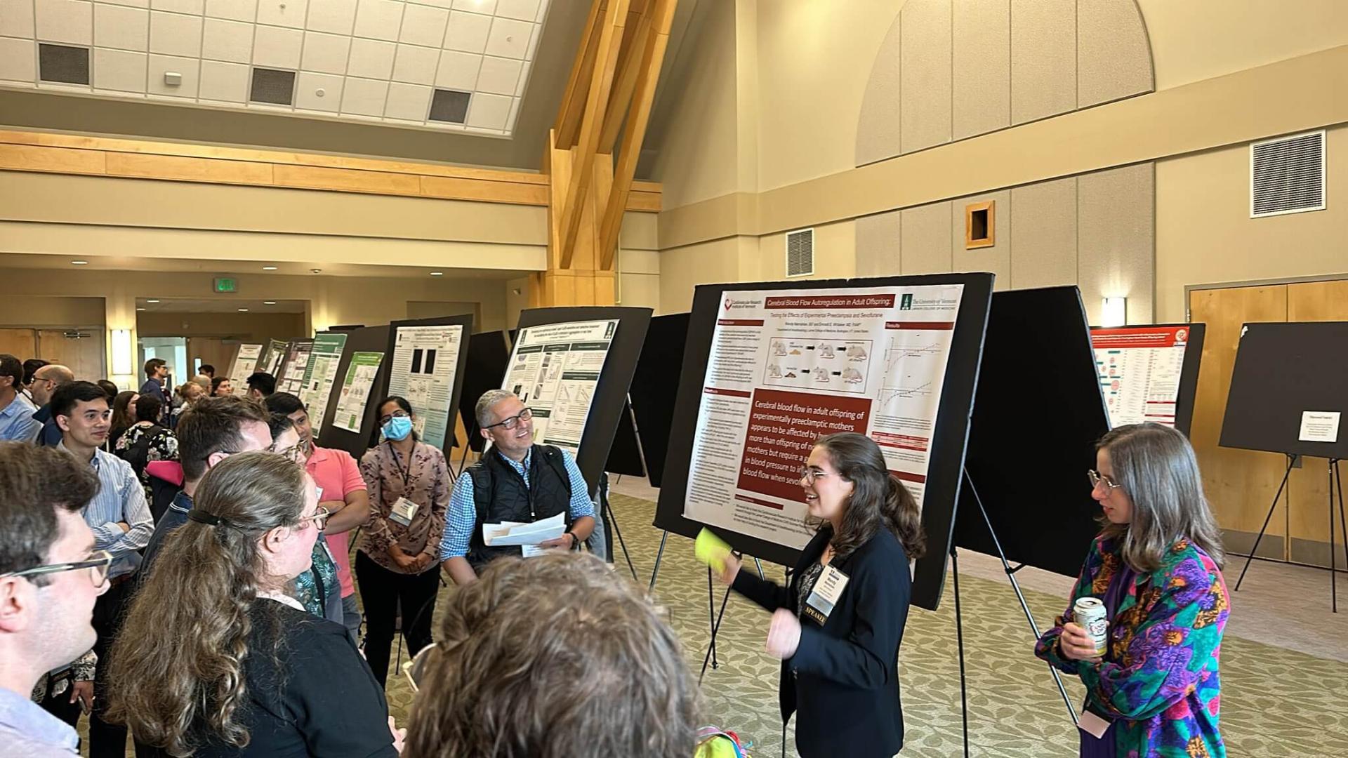 Researcher standing and presenting their findings on a large projection screen.