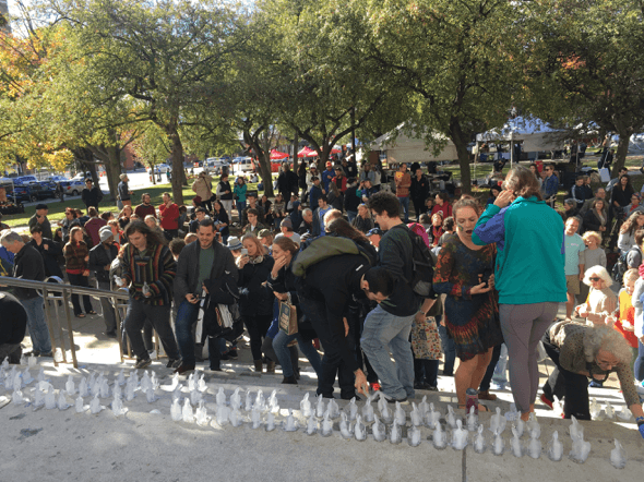 Large group of people watching ice sculpture
