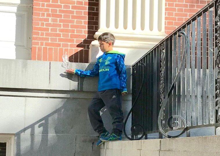 Kid holding a ice sculpture on his hand