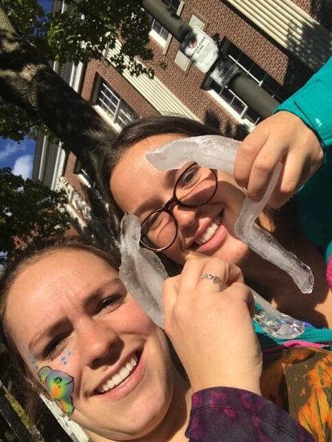 two people holding a ice sculpture