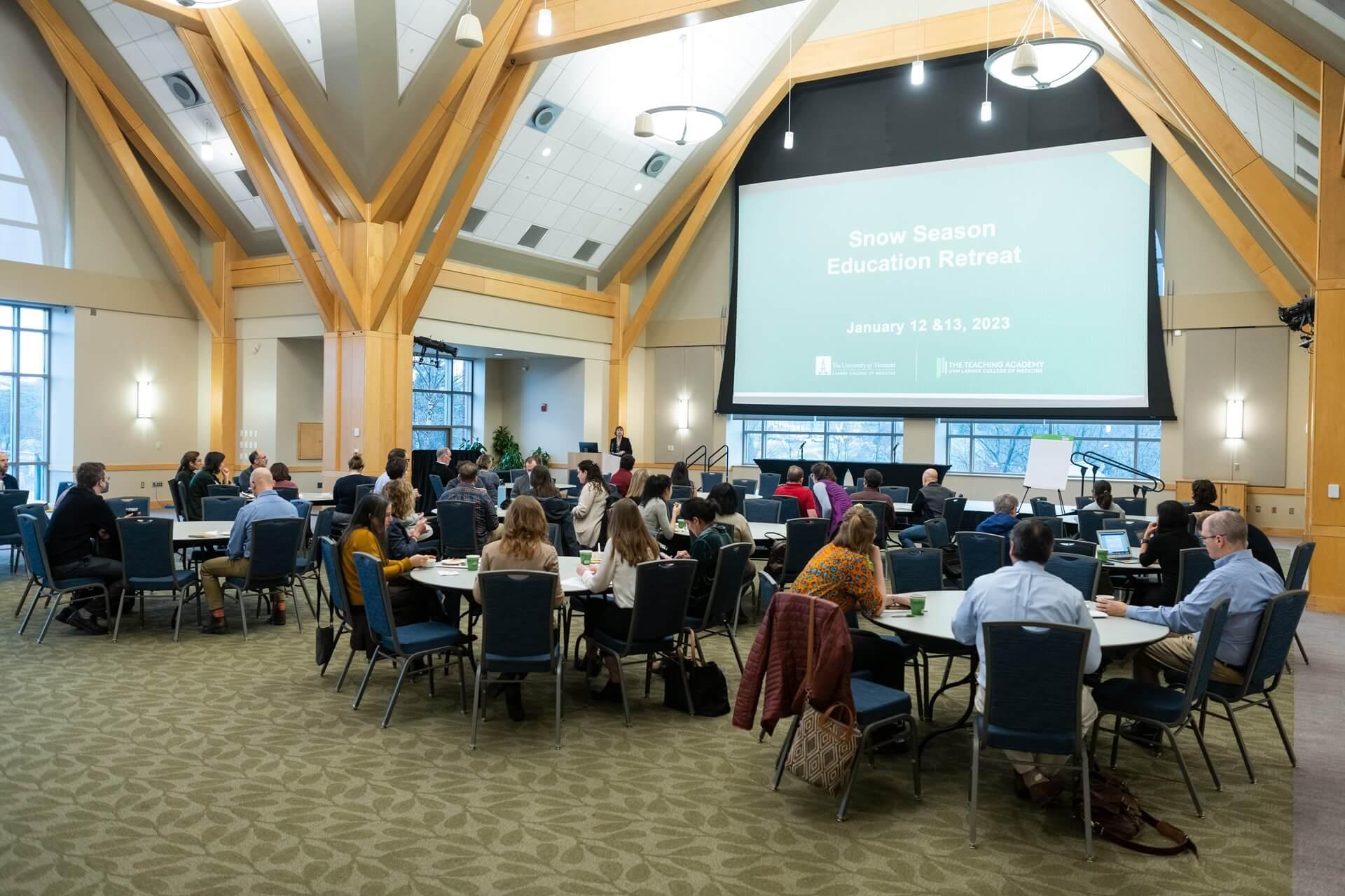 audience at tables in a large meeting room