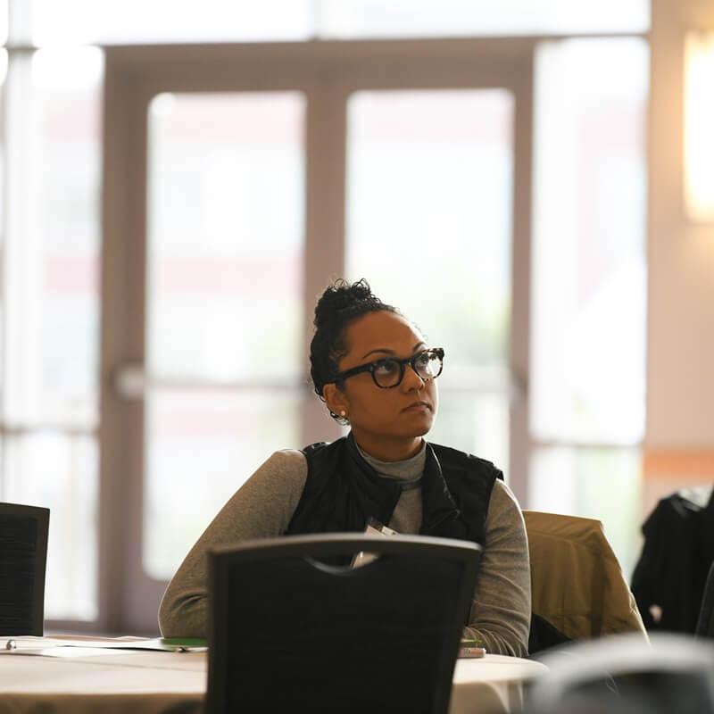Person at a table listening intently