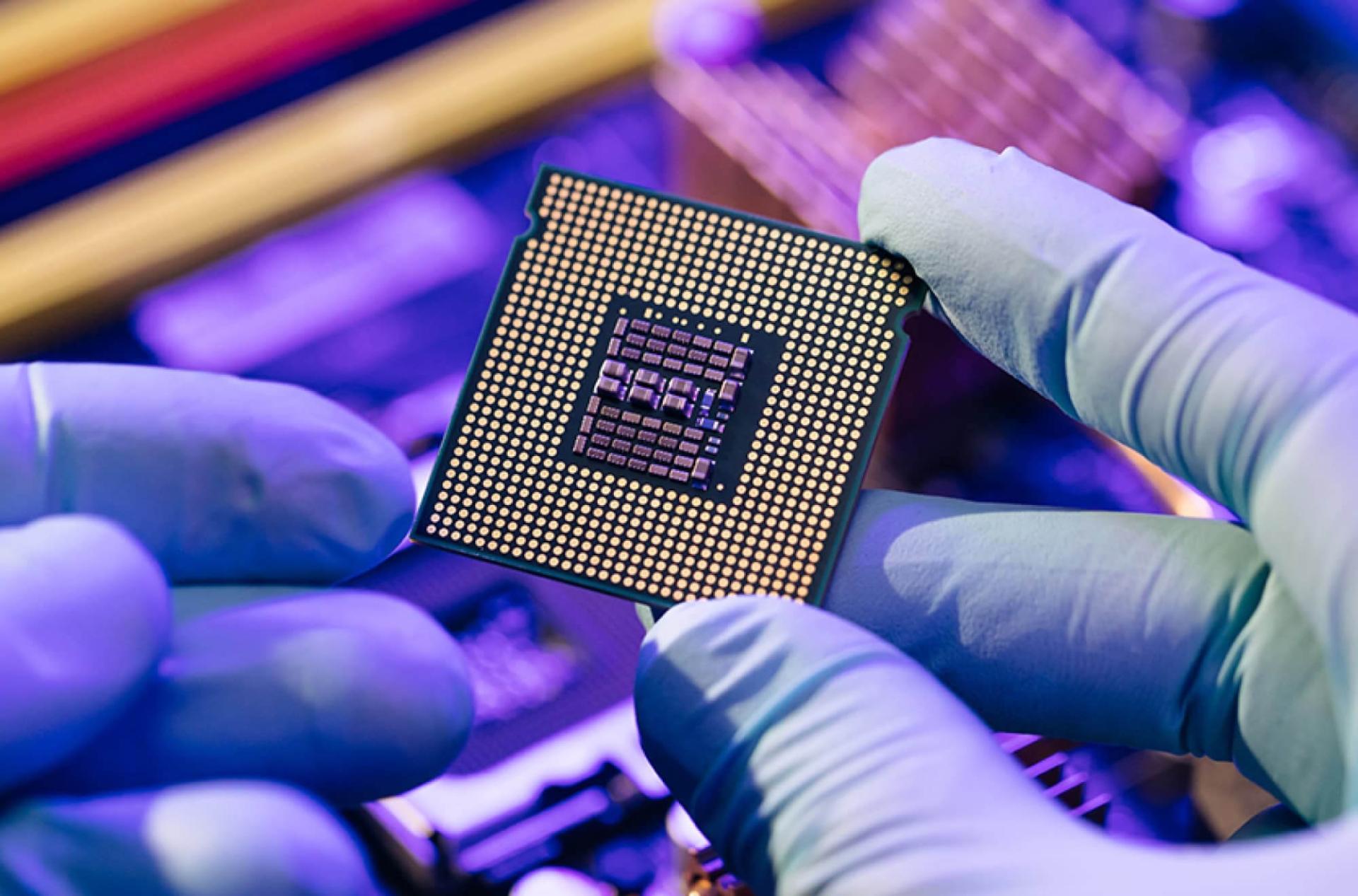 Hands holding a computer chip