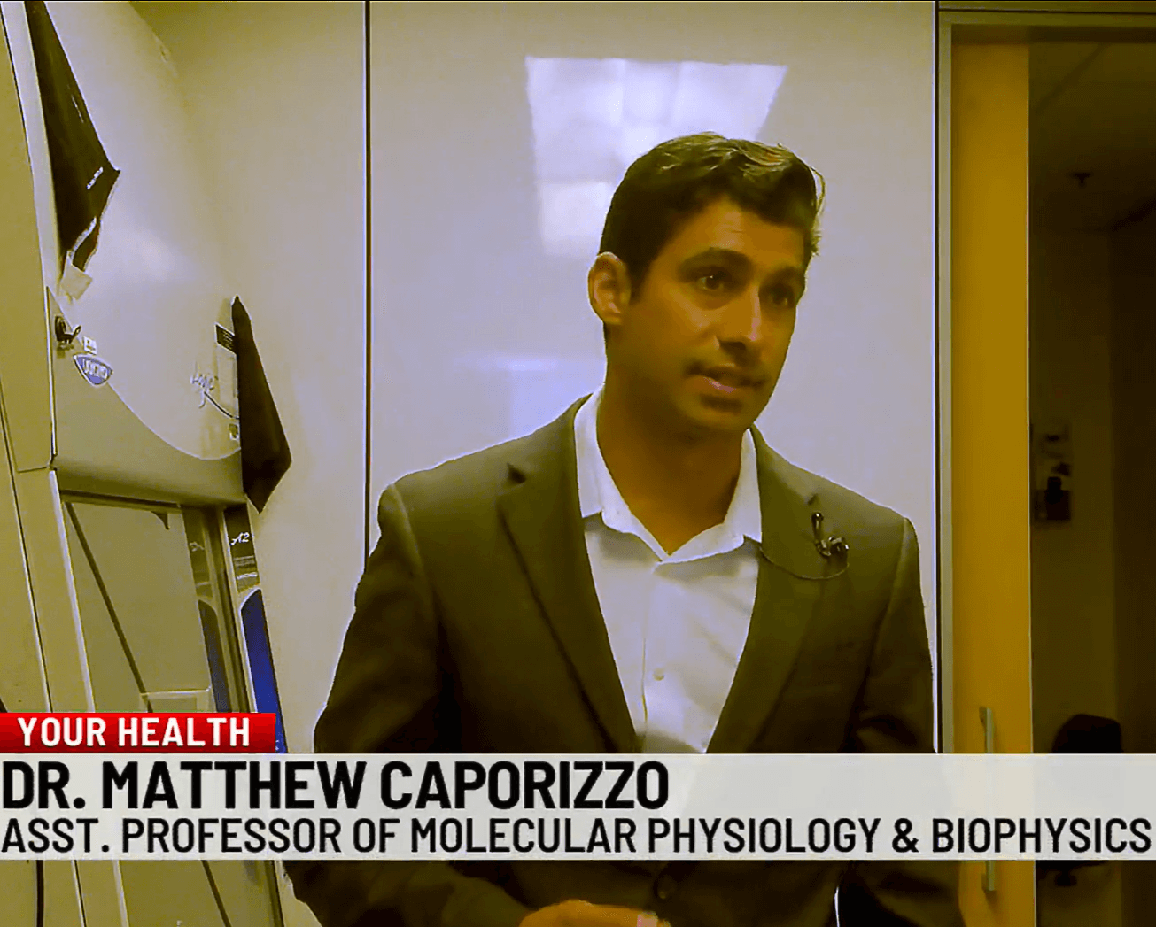 Image captured during a news interview with a researcher inside.