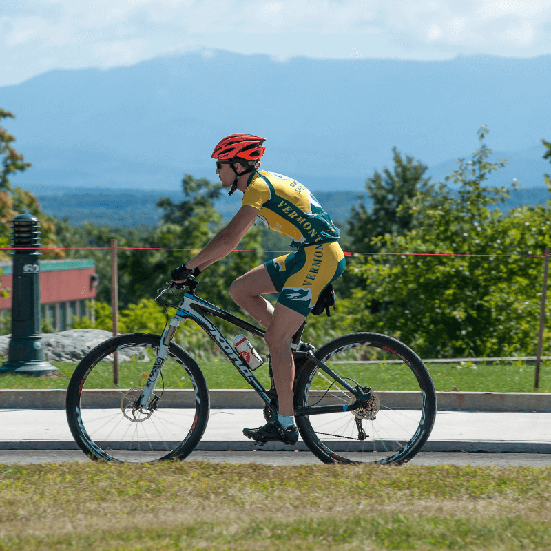 Person riding a bike with mountains in background