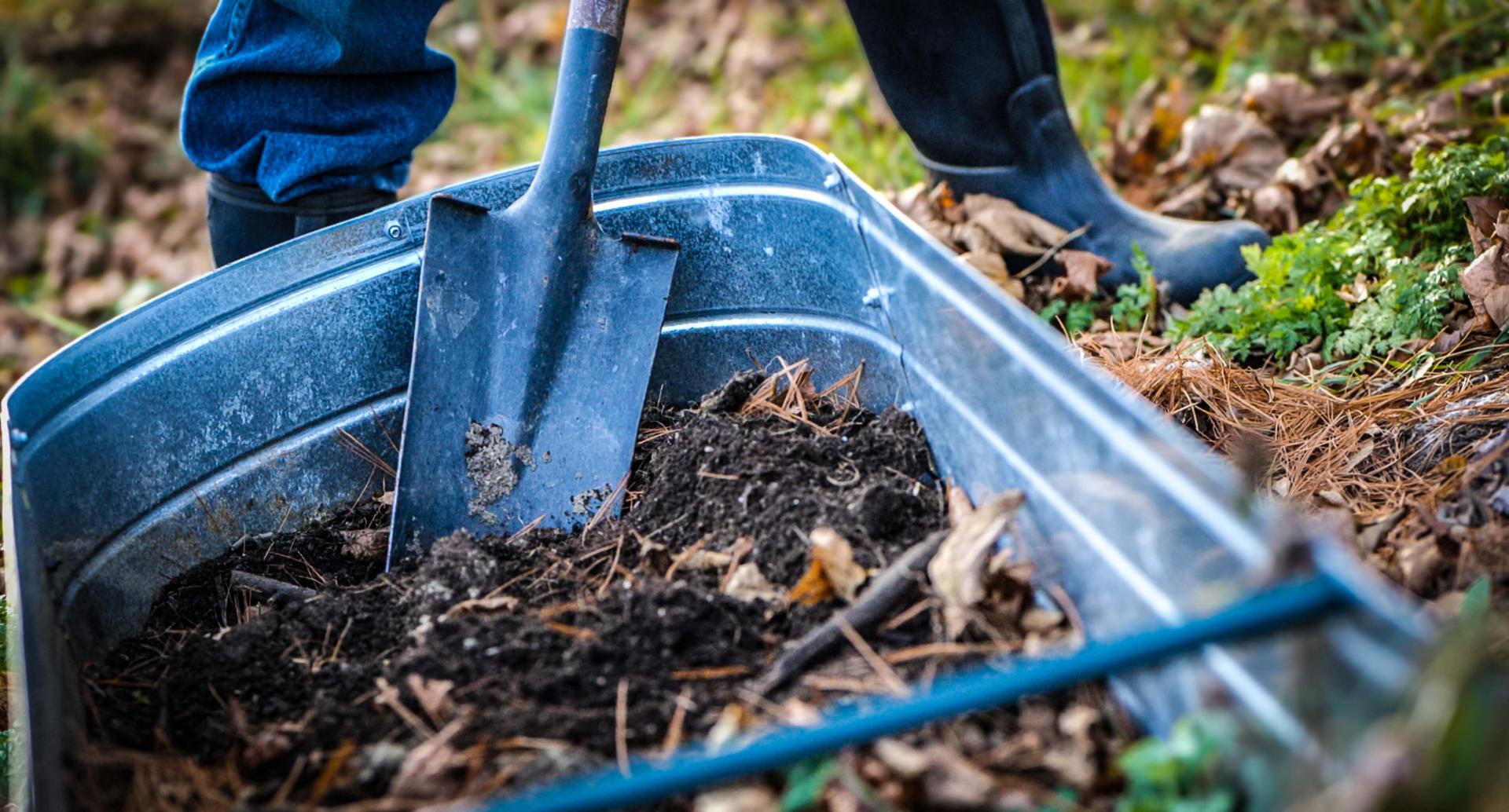 shovel in the dirt in a raised bed