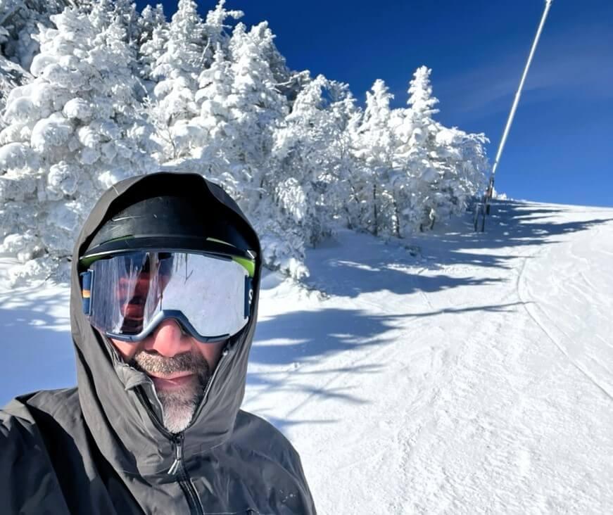 Peter Newman on a ski hill wearing goggles and a helmet
