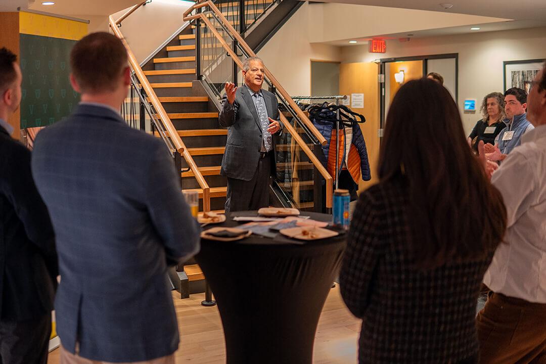 Dean Sanjay Sharma addresses the audience at the Champlain Investment Partners event.
