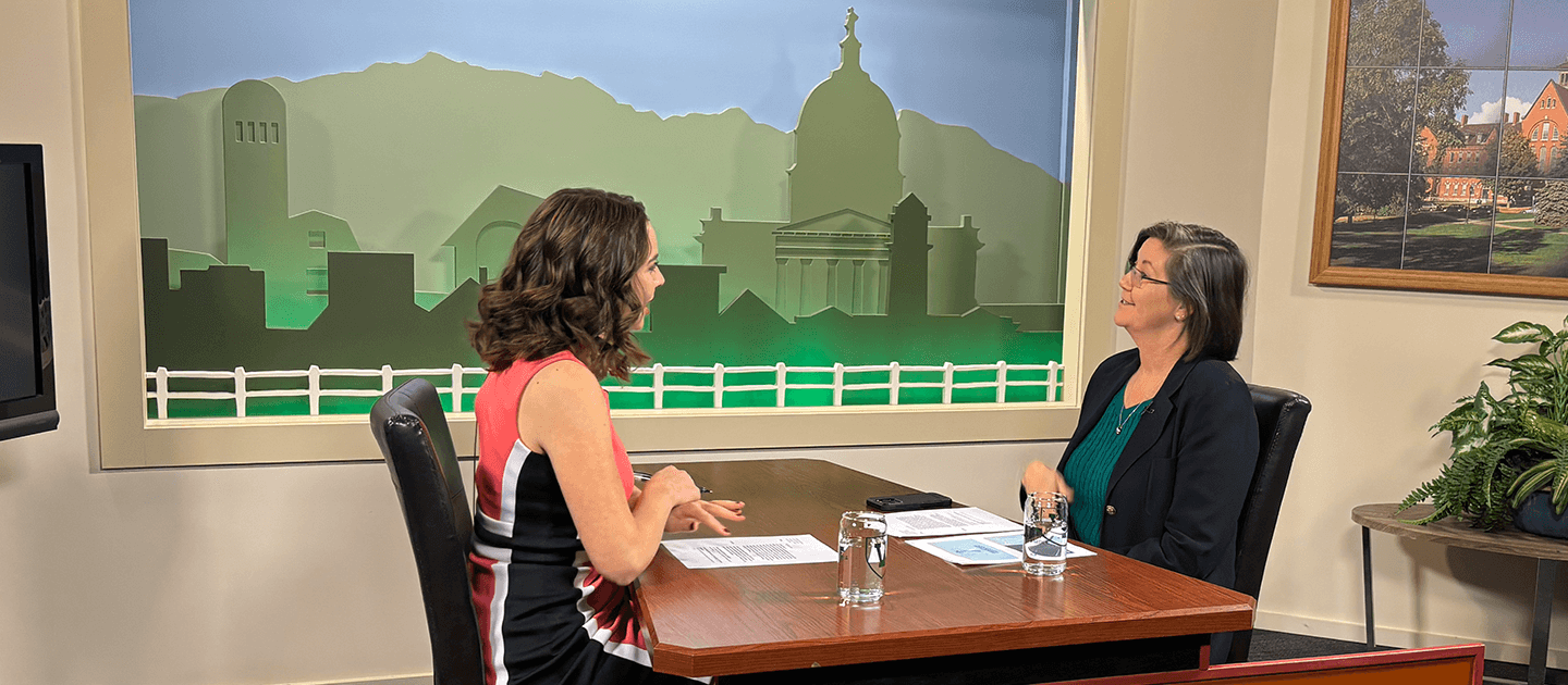 two women sitting at a table talking