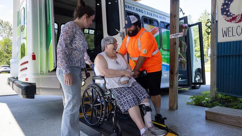 Vermont transit rider is assisted off the bus