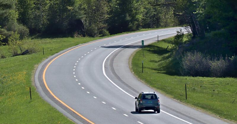 Car traveling on a rural road in Vermont
