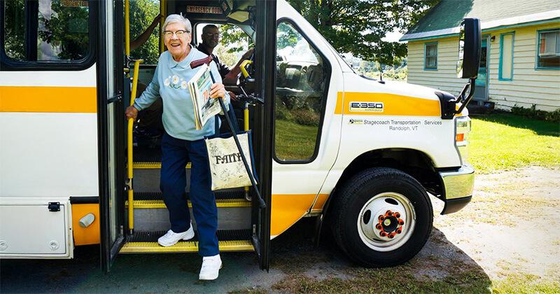 a rural transit rider disembarks at her home