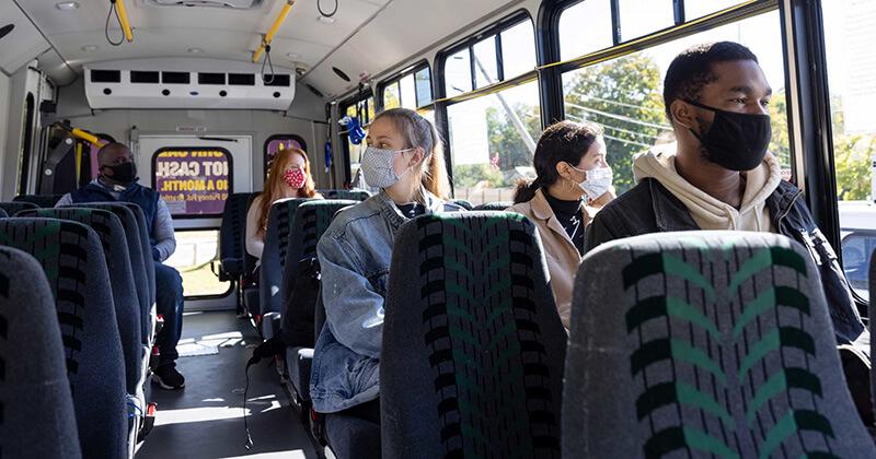 Masked riders on a transit bus during COVID