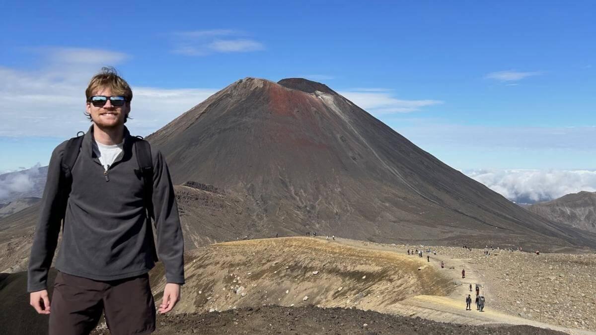 Cole standing in front of a mountain in New Zealand.