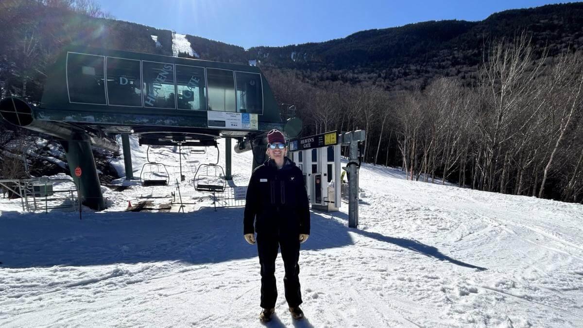 Cole standing in front of a chairlift at Sugarbush.