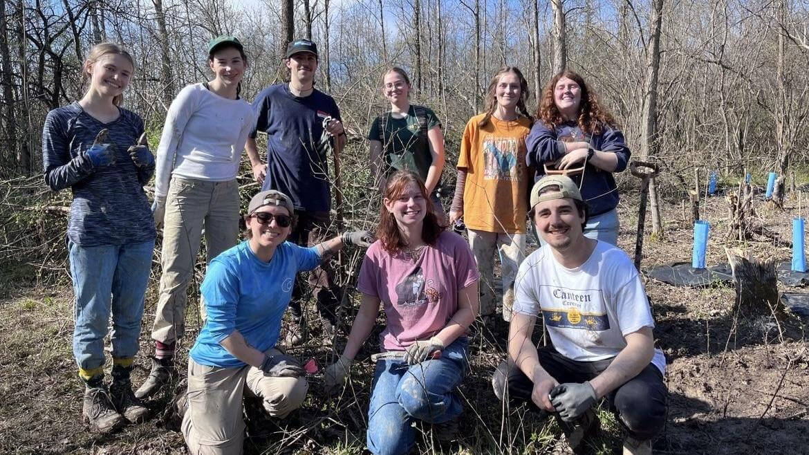 Gus and his classmates posing for a photo in Charlotte Park and Wildlife Refuge while completing a service learning project.