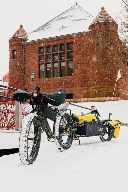 A bike in the snow outside of the memorial service at Ira Allen chapel