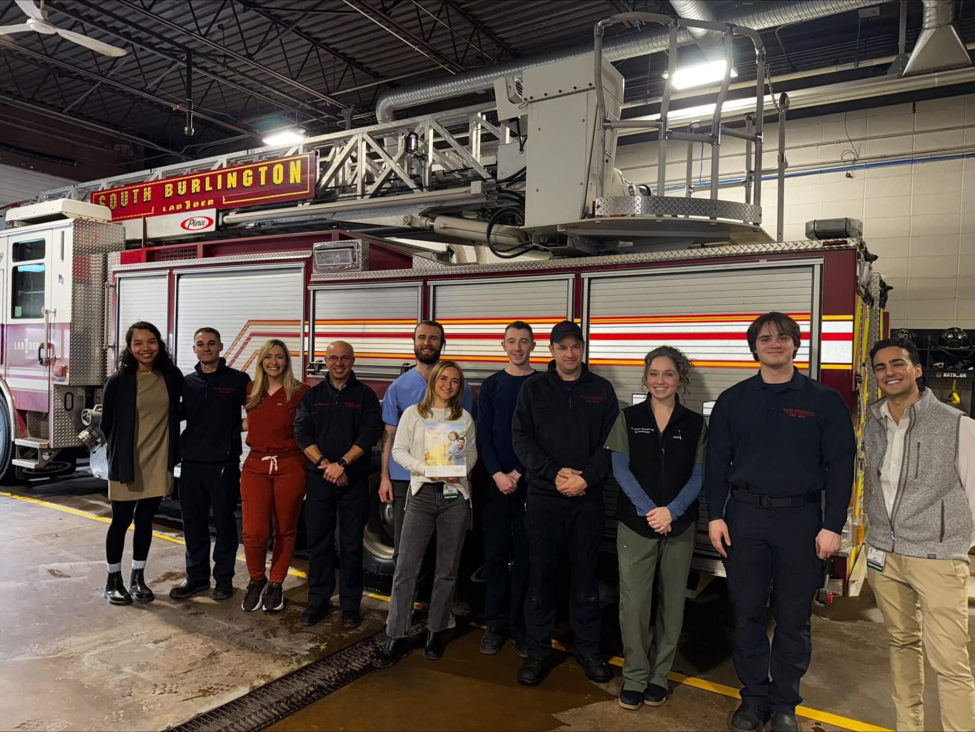 Group photo of dermatology students with South Burlington firefighters