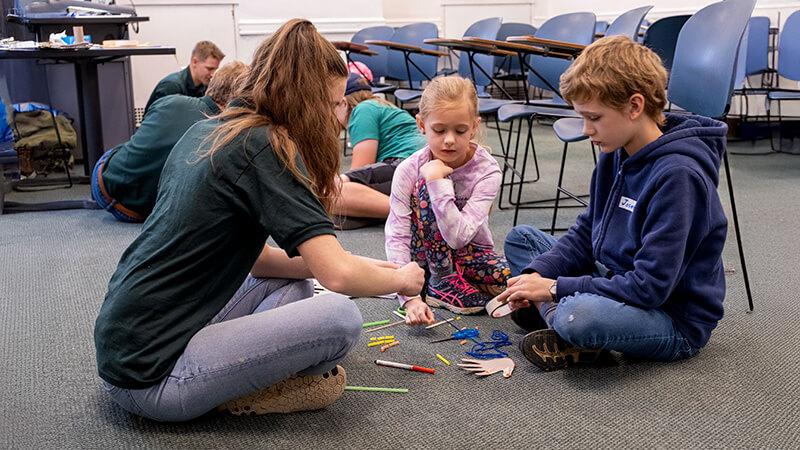 STEM Ambassador helping students during an on-campus program