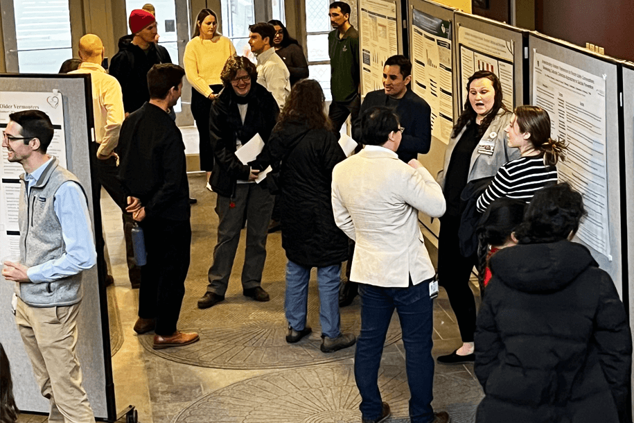 a group of people at a poster session