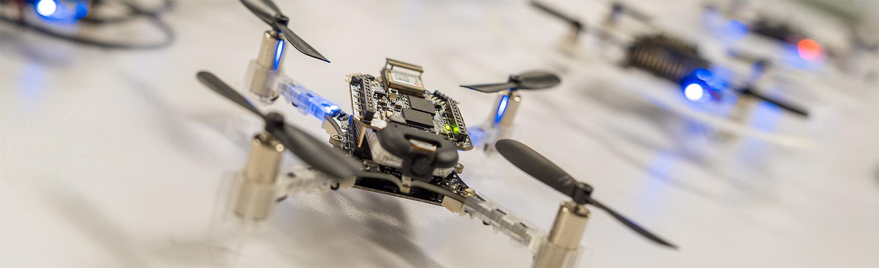 A fleet of small drones ready for take-off in a CEMS autonomy research lab
