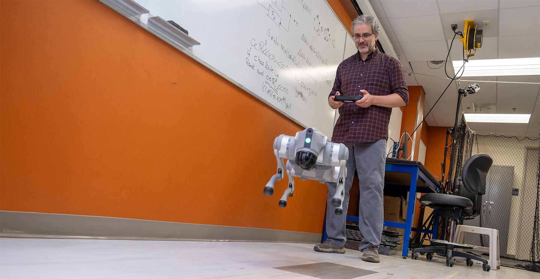Professor Luis Dufault Espinosa controlling a robotic "dog"