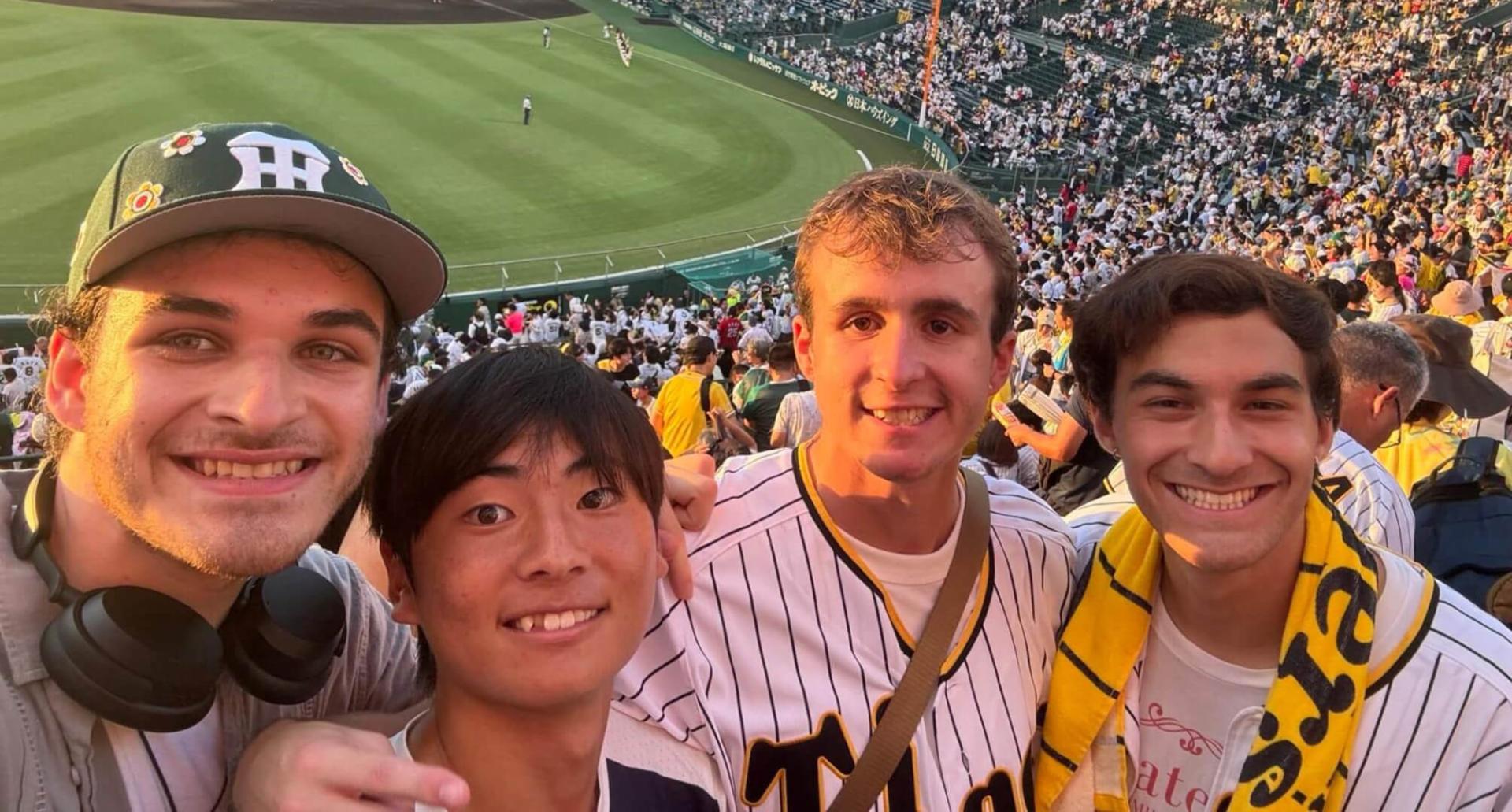 four people attending a baseball game