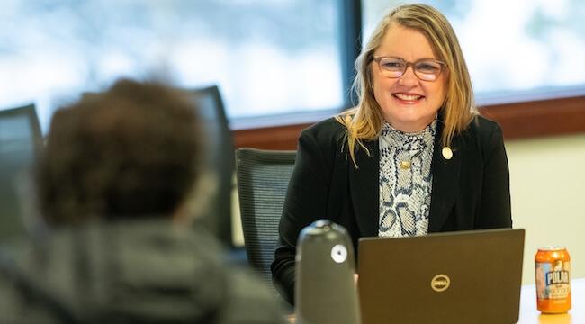 Dr. Cushman sitting at a table talking