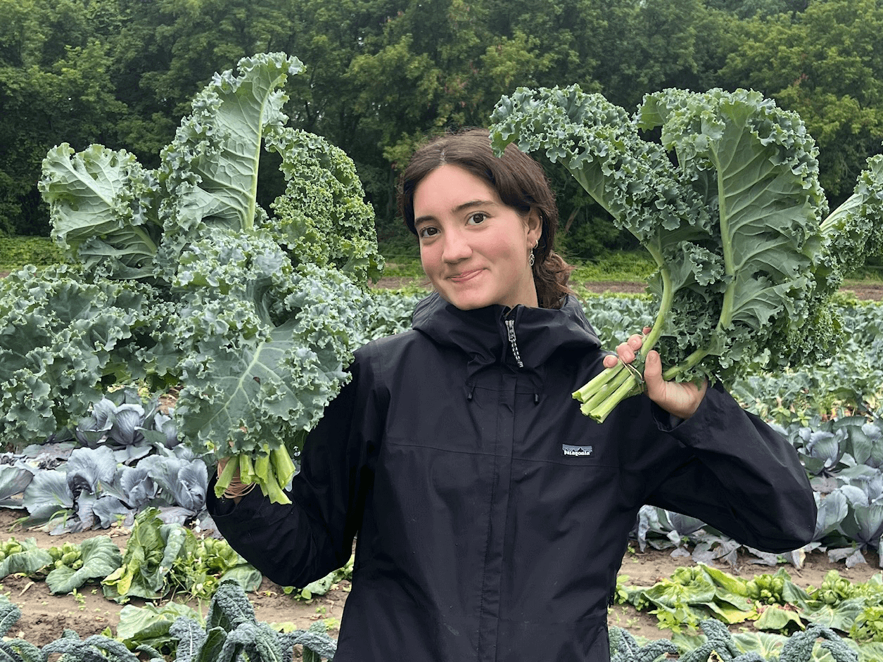 Student holding up kale