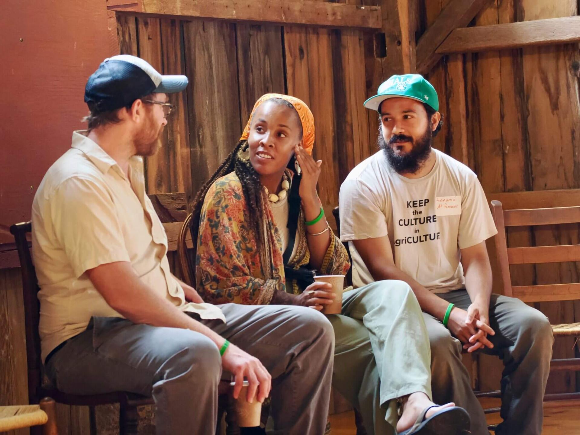 Graham Unangst-Rufenacht, policy director for Rural Vermont (left), speaks with Amber Tamm, head florist at the Catamount Farm, and tanamá varas, Catamount Farm Manager and FTP Lead Instructor.