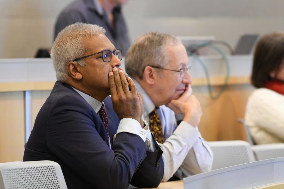 two men listening to a lecture